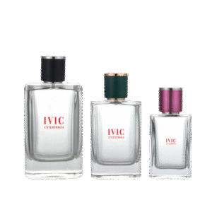 Three clear glass perfume bottles of varying sizes with different colored caps—black, green, and pink—stand side by side from Ivic Enterprises